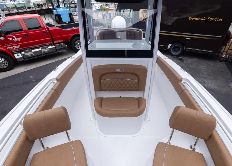 Slide: The Image of 2026 Sea Hunt Ultra 245 SE boat interior with tan seating and modern design. - 6