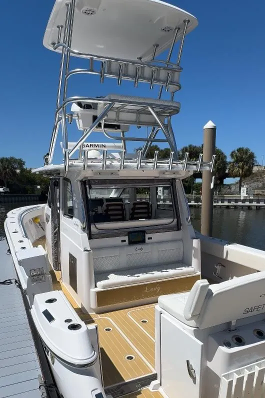 Slide: The Image of 2025 Century NAV4100 CC-H boat docked, featuring spacious deck and modern design. - 10