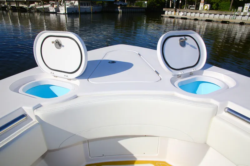 Slide: The Image of Century NAV4100 CC-H (Twins) 2025 boat with open storage compartments on a calm waterfront. - 14