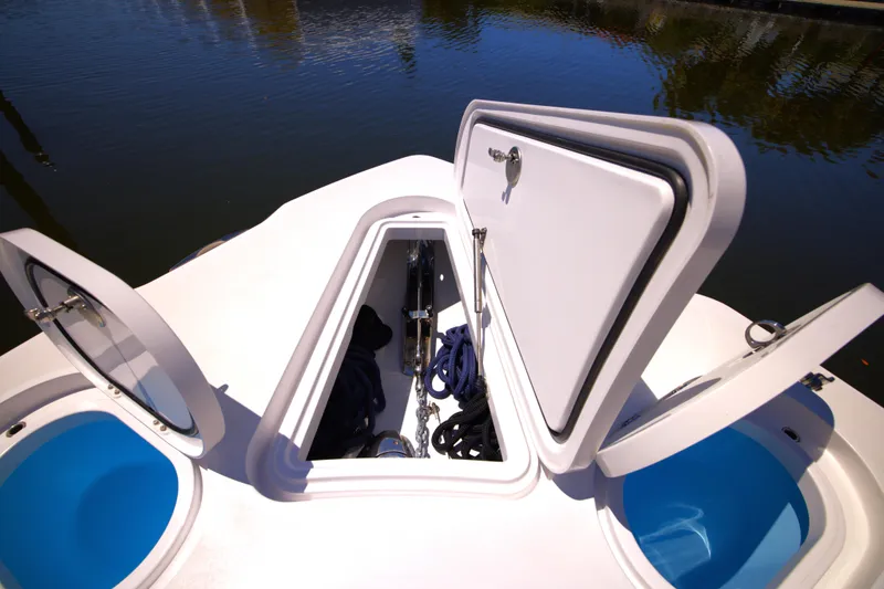 Slide: The Image of 2025 Century NAV4100 CC-H boat storage compartments open on calm water. - 15