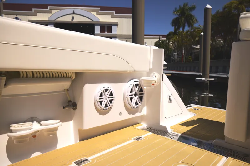 Slide: The Image of Century NAV4100 CC-H (Twins) 2025 boat interior with speakers and dock view. - 21