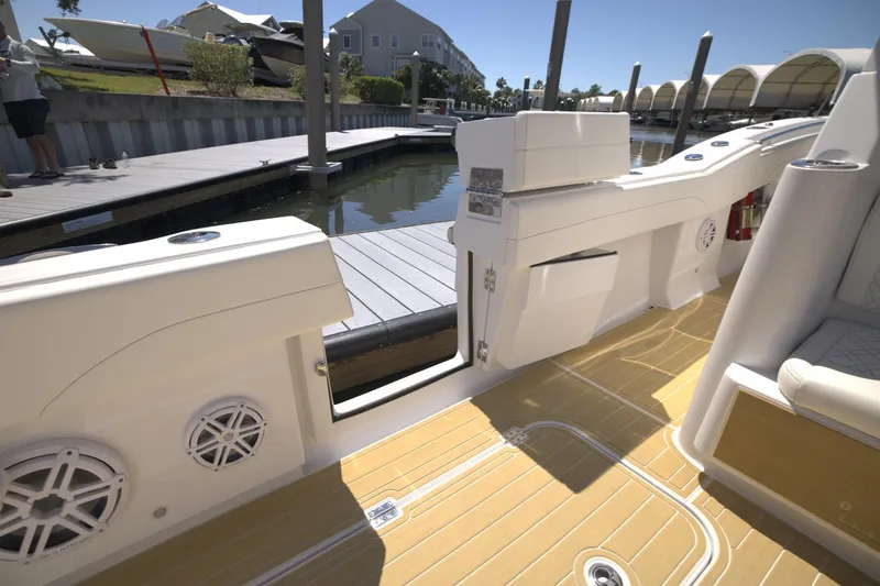 Slide: The Image of 2025 Century NAV4100 CC-H boat interior with open side door, docked at marina. - 22