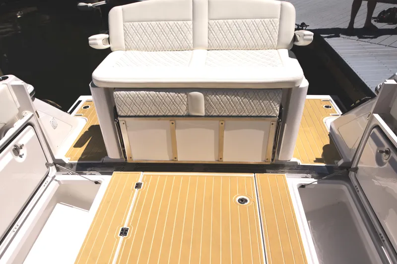 Slide: The Image of Century NAV4100 CC-H (Twins) 2025 boat interior with cushioned seating and teak flooring. - 23