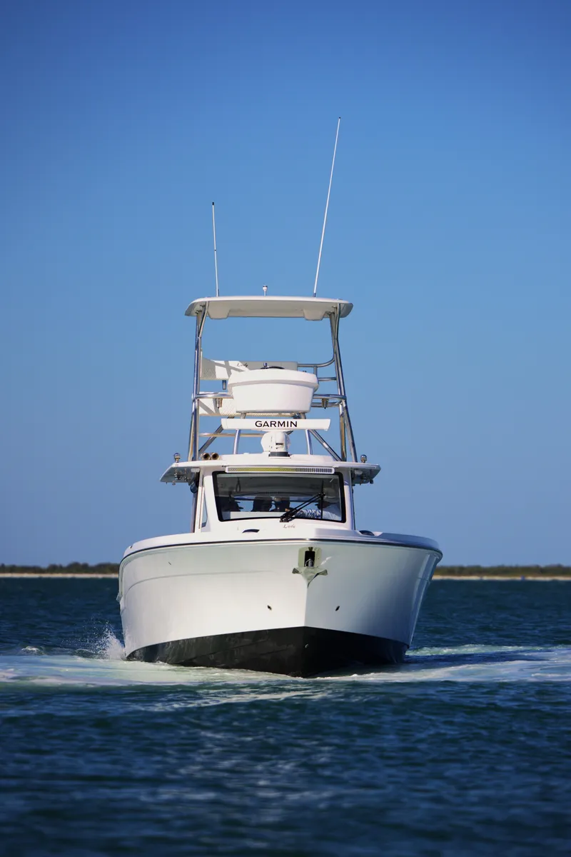 Slide: The Image of 2025 Century NAV4100 CC-H boat cruising on open water under clear blue sky. - 3