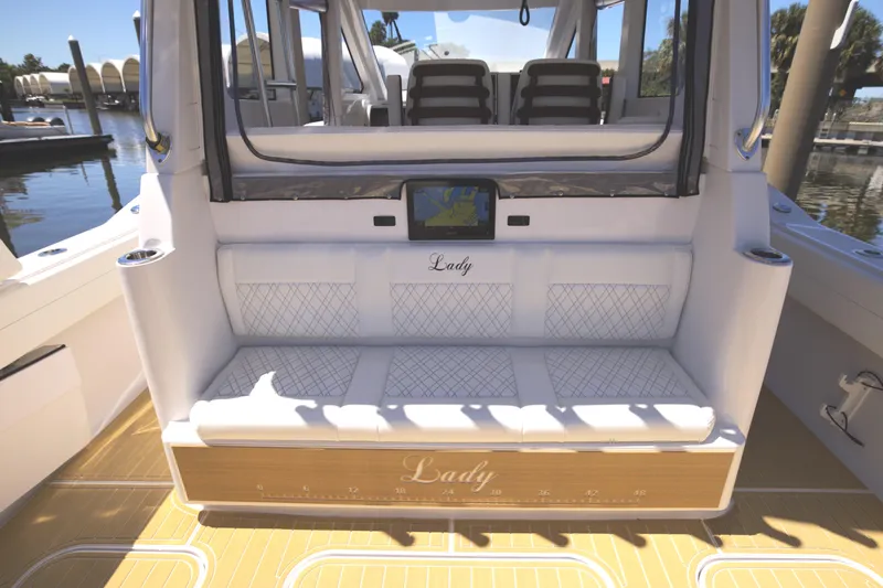 Slide: The Image of Century NAV4100 CC-H (Twins) 2025 boat interior with cushioned seating and navigation display. - 30