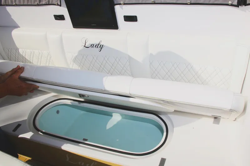 Slide: The Image of Luxurious Century NAV4100 CC-H boat interior with white seating and built-in storage, 2025 model. - 32