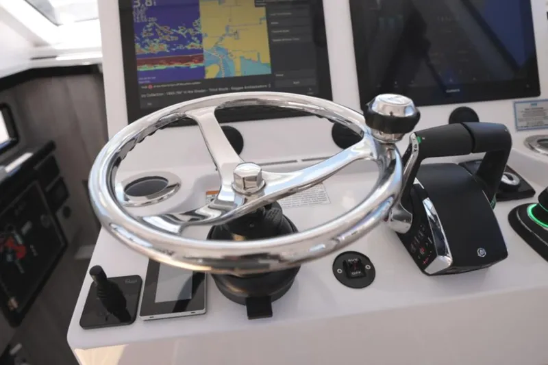 Slide: The Image of Steering wheel and controls of 2025 Century NAV4100 CC-H boat with navigation screens. - 38