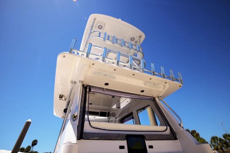 Slide: The Image of 2025 Century NAV4100 CC-H boat, viewed from below, showcasing sleek design against clear blue sky. - 42