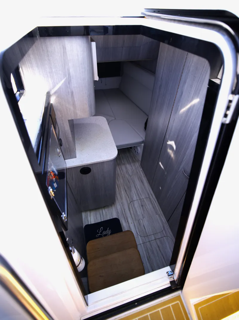 Slide: The Image of Interior view of 2025 Century NAV4100 CC-H boat cabin, featuring modern design and compact layout. - 44