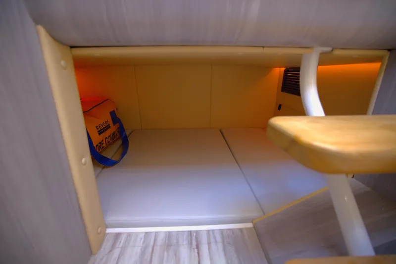 Slide: The Image of Interior cabin space of 2025 Century NAV4100 CC-H boat, featuring wooden steps and ambient lighting. - 47