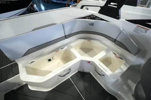 Slide: The Image of 2025 Bayliner V20i boat interior with spacious storage compartments and sleek seating design. - 11