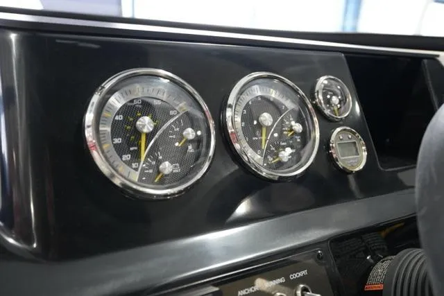 Slide: The Image of Dashboard of 2025 Bayliner V20i boat with analog gauges and controls. - 14