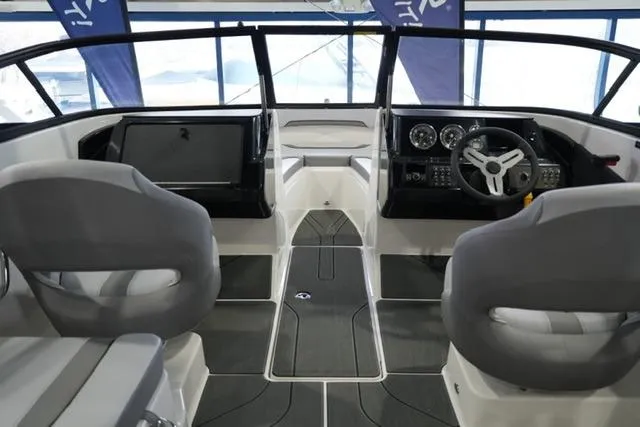 Slide: The Image of Interior of 2025 Bayliner V20i boat with modern dashboard and seating. - 6