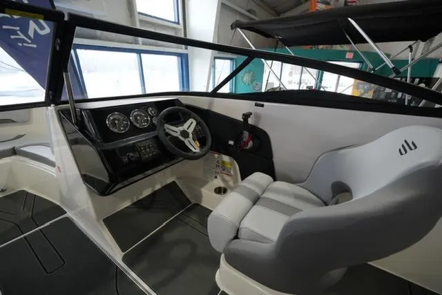 Slide: The Image of 2025 Bayliner V20i boat interior with steering wheel and modern dashboard. - 7