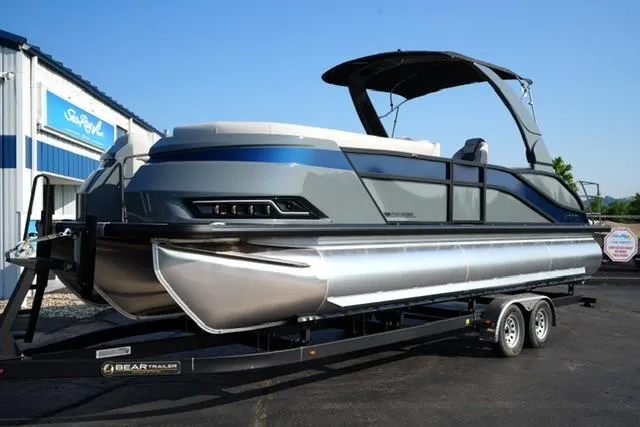 The Image of 2025 Harris Grand Mariner 250 pontoon boat on trailer, sleek design, parked outdoors. - 0