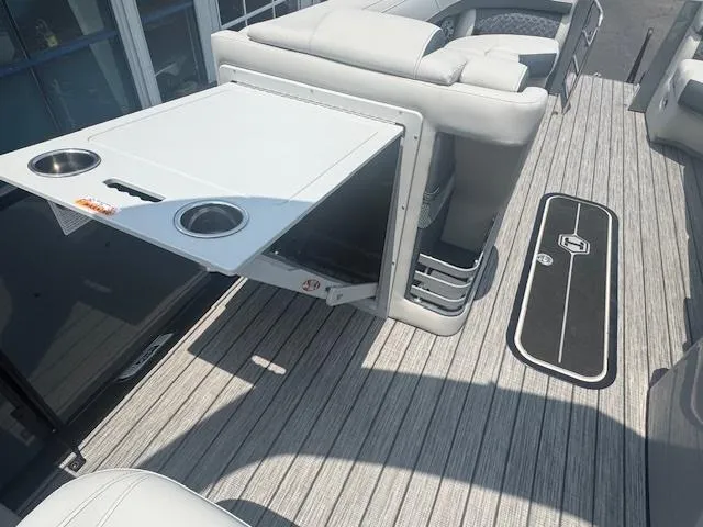 Slide: The Image of 2025 Harris Grand Mariner 250 boat interior with fold-out table and cup holders. - 13