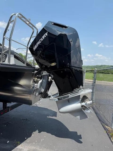 Slide: The Image of 2025 Harris Grand Mariner 250 with Mercury outboard engine, parked outdoors. - 17