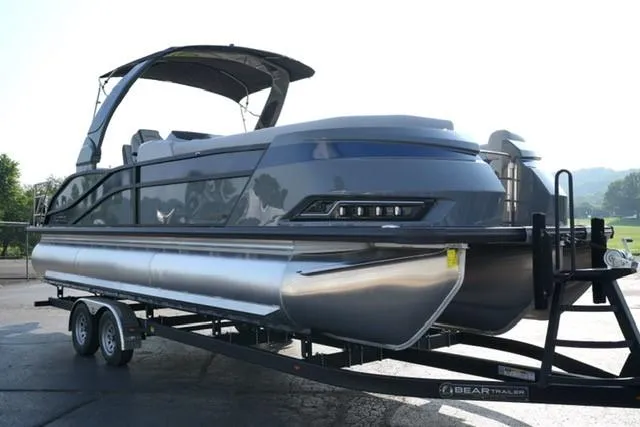 Slide: The Image of 2025 Harris Grand Mariner 250 pontoon boat on trailer, sleek design, modern features. - 19