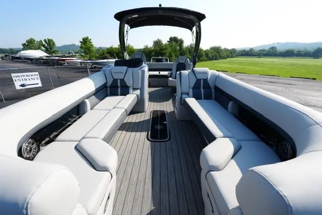 Slide: The Image of 2025 Harris Grand Mariner 250 pontoon boat with spacious seating and modern design. - 24