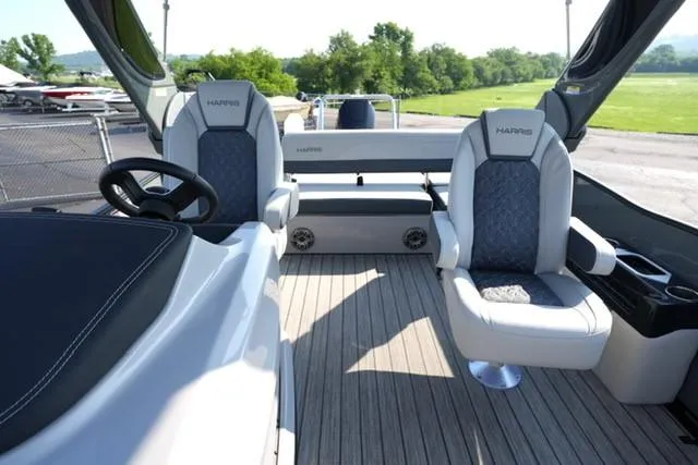 Slide: The Image of 2025 Harris Grand Mariner 250 boat interior with luxury seating and steering wheel. - 26