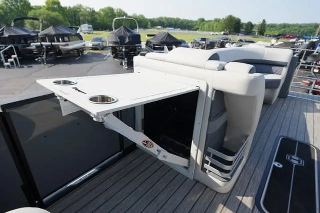 Slide: The Image of 2025 Harris Grand Mariner 250 boat interior with foldable table and cup holders. - 27
