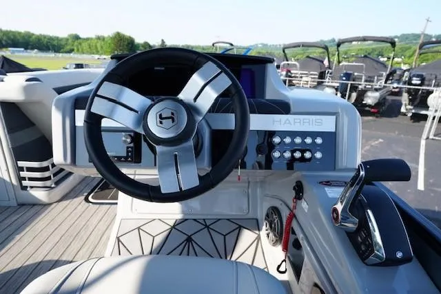 Slide: The Image of 2025 Harris Grand Mariner 250 helm with modern steering wheel and control panel. - 29
