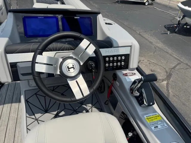 Slide: The Image of 2025 Harris Grand Mariner 250 dashboard with steering wheel and dual screens. - 6