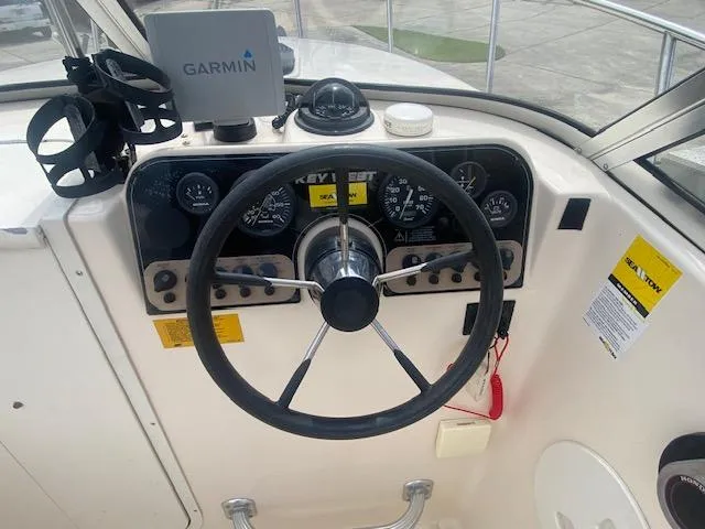 Slide: The Image of Steering wheel and dashboard of a 2003 Key West 2020 Walkaround boat with Garmin GPS. - 13