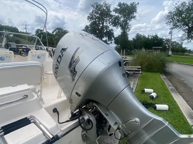 Slide: The Image of Key West 2020 Walkaround boat with Honda outboard motor, parked outdoors. - 15