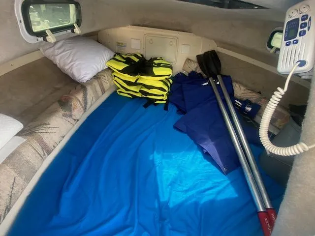 Slide: The Image of Interior of 2003 Key West 2020 Walkaround boat with life jackets and paddles. - 18