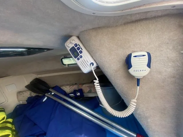 Slide: The Image of Interior of 2003 Key West 2020 Walkaround boat with radio equipment and blue gear. - 19