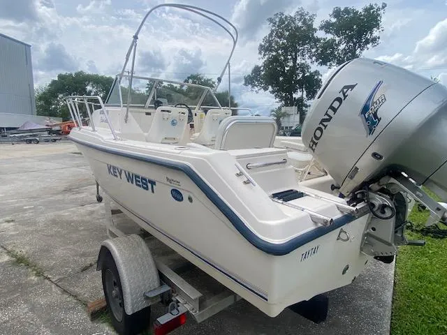 Slide: The Image of 2003 Key West 2020 Walkaround boat on trailer with Honda outboard motor. - 2