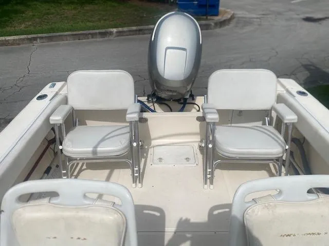 Slide: The Image of 2003 Key West 2020 Walkaround boat interior with seating and outboard motor. - 3