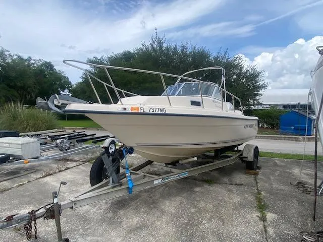 Slide: The Image of Key West 2020 Walkaround boat on trailer, 2003 model, parked outdoors. - 4