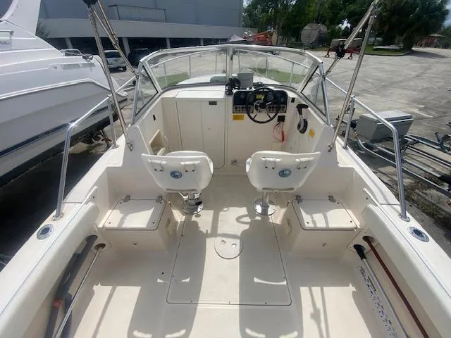 Slide: The Image of 2003 Key West 2020 Walkaround boat interior with dual seats and steering console. - 6