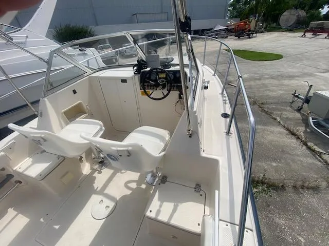 Slide: The Image of 2003 Key West 2020 Walkaround boat interior with dual seats and steering console. - 7