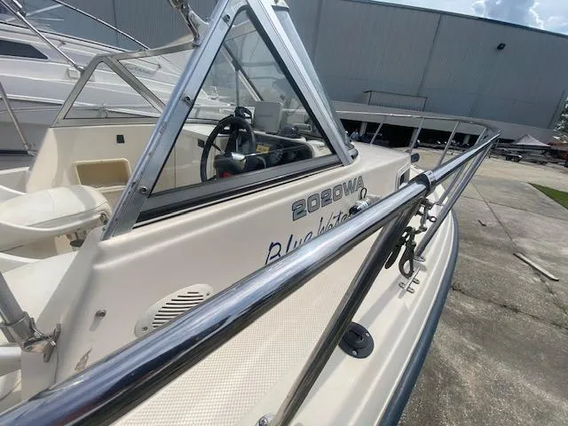 Slide: The Image of 2003 Key West 2020 Walkaround boat, side view, docked outdoors. - 8