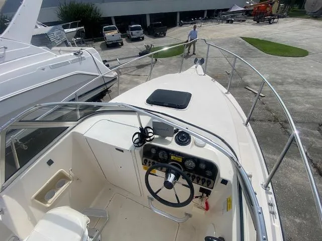 Slide: The Image of Key West 2020 Walkaround boat, 2003 model, docked with visible steering console and deck area. - 9