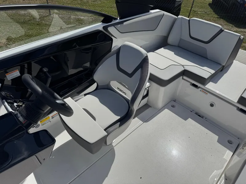 Slide: The Image of 2025 Yamaha Boats AR220 interior with sleek seating and modern steering console. - 14