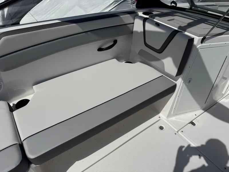 Slide: The Image of 2025 Yamaha Boats AR220 interior seating area with sleek, modern design and comfortable upholstery. - 17