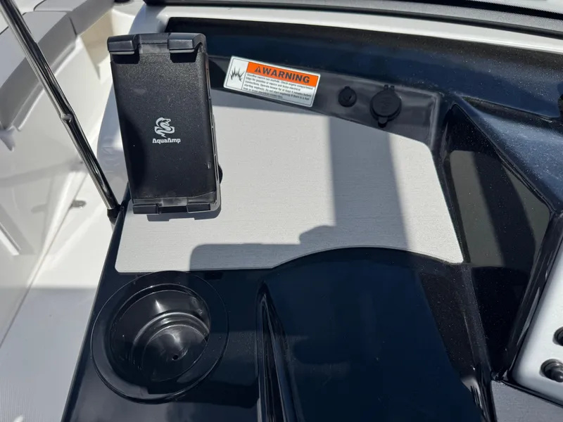 Slide: The Image of 2025 Yamaha Boats AR220 dashboard with phone holder and cup holder. - 21