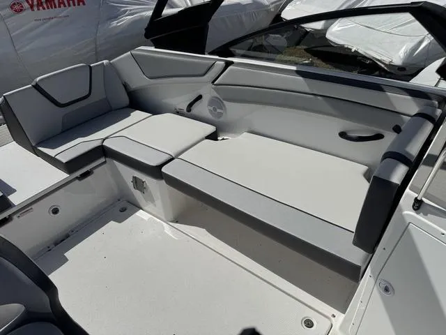 Slide: The Image of 2025 Yamaha Boats AR220 interior seating with modern design and gray upholstery. - 13