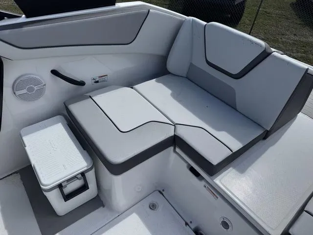 Slide: The Image of 2025 Yamaha Boats AR220 interior seating with modern design and storage compartment. - 15