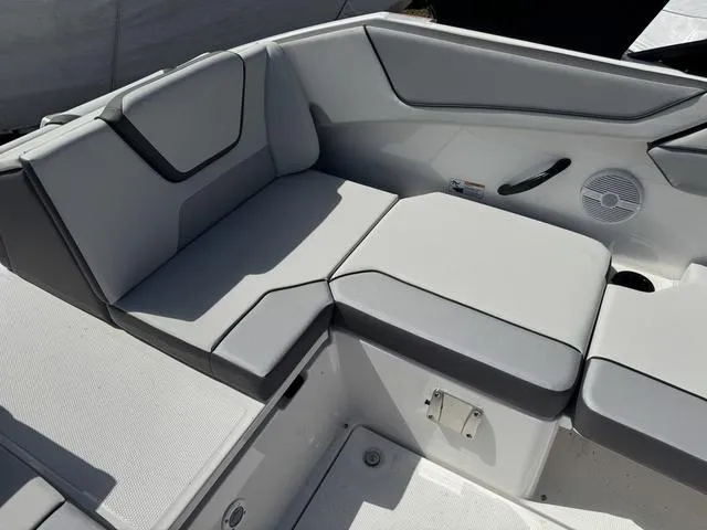 Slide: The Image of 2025 Yamaha Boats AR220 interior seating with gray upholstery and modern design. - 16