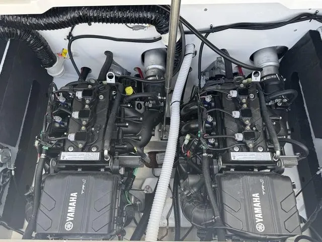 Slide: The Image of 2025 Yamaha AR220 boat engines, showcasing dual powerful motors and intricate wiring. - 22