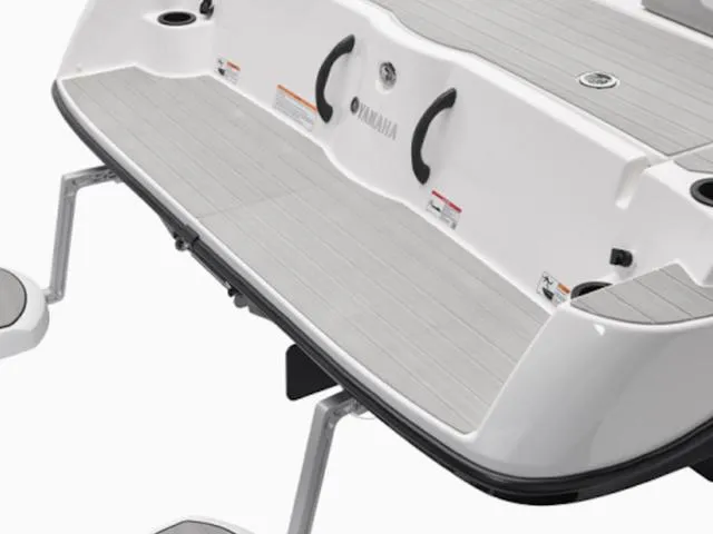 Slide: The Image of 2025 Yamaha Boats AR220 swim platform with sleek design and sturdy handles. - 26