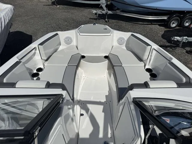 Slide: The Image of 2025 Yamaha Boats AR220 interior with spacious seating and cup holders. - 7