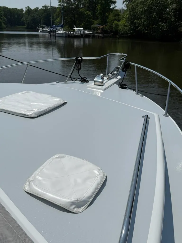 Slide: The Image of Bow of 2004 Mabry 40 yacht on calm river with lush greenery. - 11
