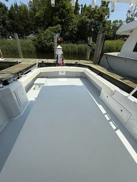 Slide: The Image of 2004 Mabry 40 boat deck at a dock, surrounded by greenery. - 15