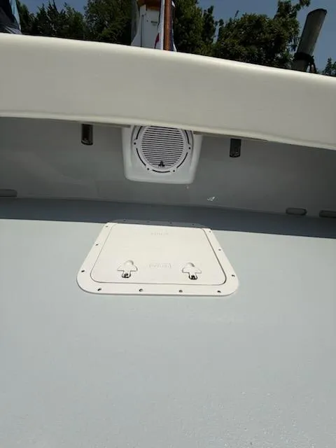 Slide: The Image of 2004 Mabry 40 boat interior with speaker and hatch, under clear sky. - 16